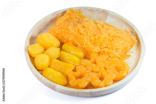 Close up Amazing traditional Thai desserts call Foi Thong, Thong yip and Thong Yod isolated on white background with clipping path. Thai sweet dessert made from eggs, coconut and bean cooked in syrup.