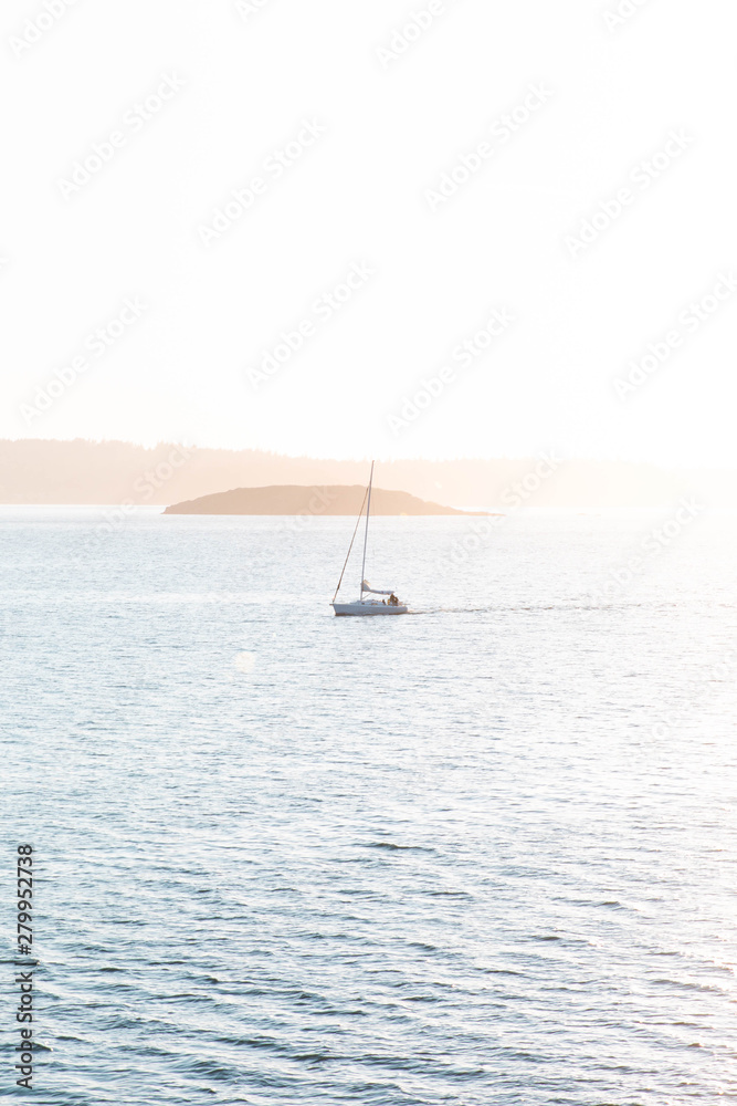 Scenic view of sailboat in front of sunset Scenic view of sailboat in front of sunset