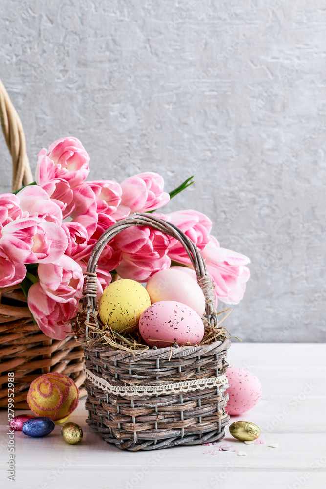 Bouquet of pink tulips and basket of Easter eggs