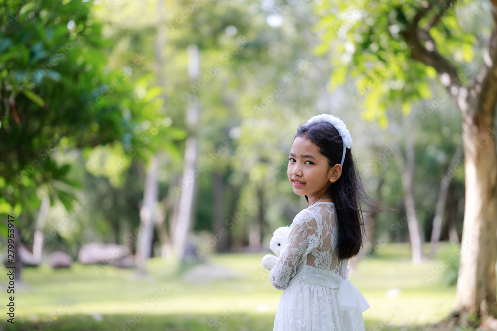 Portrait of little Asian girl smiling in the nature forest with soft tone processed Portrait of little Asian girl smiling in the nature forest with soft tone processed