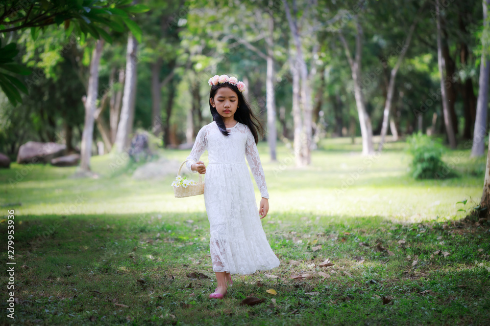 Portrait of little Asian girl walking in the nature forest with soft tone processed Portrait of little Asian girl walking in the nature forest with soft tone processed