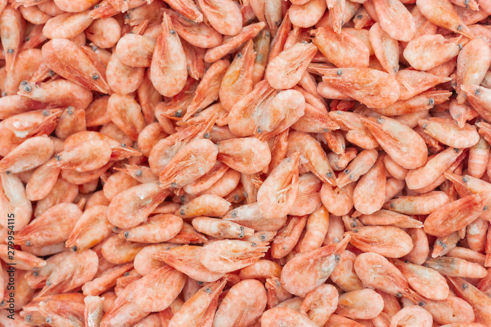 Pink fresh frozen shrimps with ice in a supermarket or fish shop. Uncooked seafood close up background. Fresh frozen prawns, delicacies, sea food concept, Pink fresh frozen shrimps with ice in a supermarket or fish shop. Uncooked seafood close up background. Fresh frozen prawns, delicacies, sea food concept,