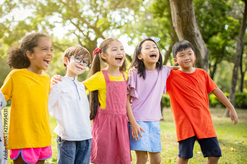 Multi-ethnic group of school kids laughing and embracing