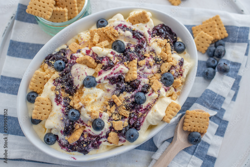 home made vanilla cheesecake ice cream with blueberries and cookies on a old table home made vanilla cheesecake ice cream with blueberries and cookies on a old table