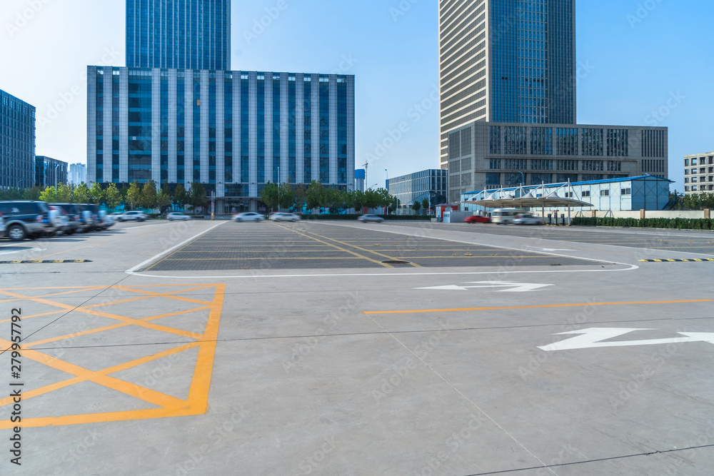 Fototapeta premium empty car park with downtown city space background
