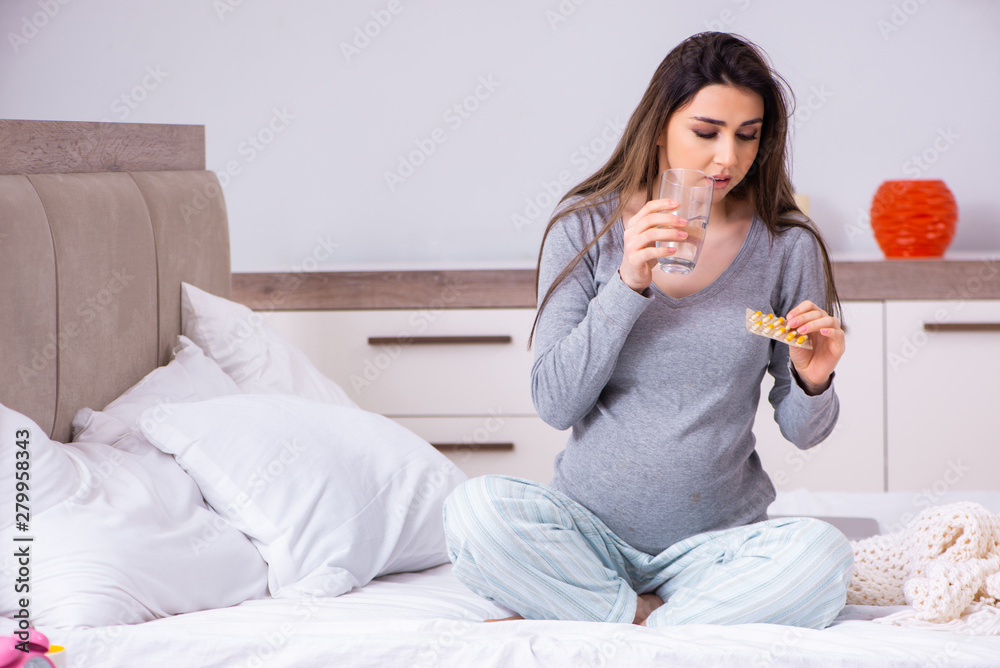 Young pregnant woman in the bedroom Young pregnant woman in the bedroom