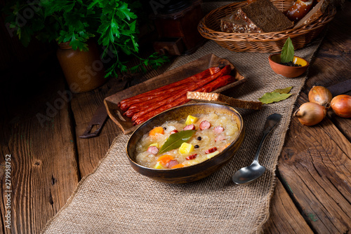 rustic sauerkraut soup with bacon and sausage photo