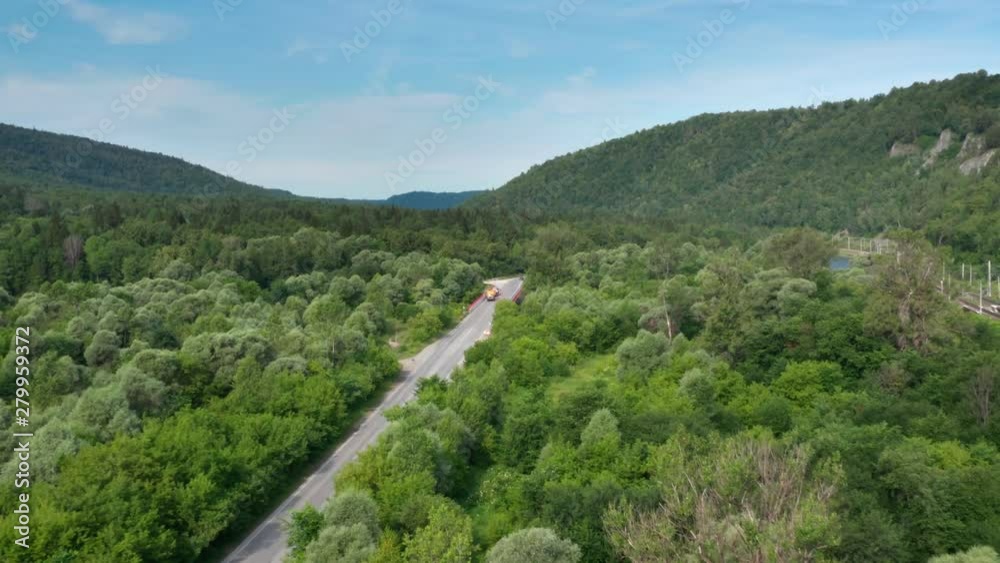 Mountains river.Cars on the bridge.Road workers.Aerial follow shot. Mountains river.Cars on the bridge.Road workers.Aerial follow shot.