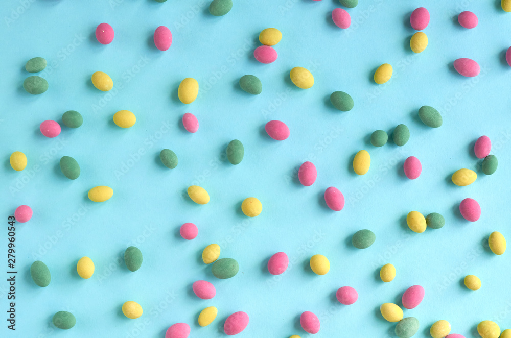 Colored sweets, peanut covered with glaze on blue background composition. Colored sweets, peanut covered with glaze on blue background composition.