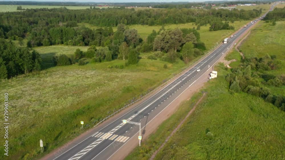 Traffic on the highway.Cars driving on the road and overtake slow trucks.Unrecognized truck passing by. Traffic on the highway.Cars driving on the road and overtake slow trucks.Unrecognized truck passing by.