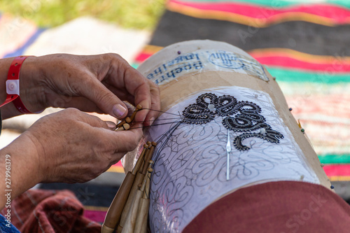 Knitting with wooden sticks on a template