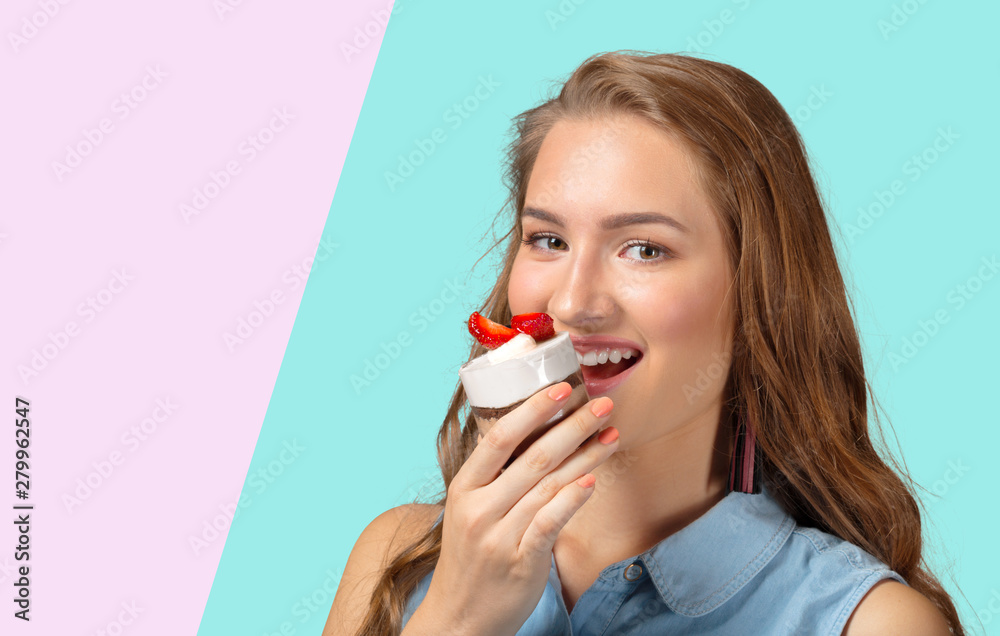 Young girl smiling with cupcake in hand Young girl smiling with cupcake in hand