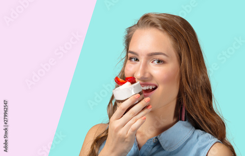 Young girl smiling with cupcake in hand