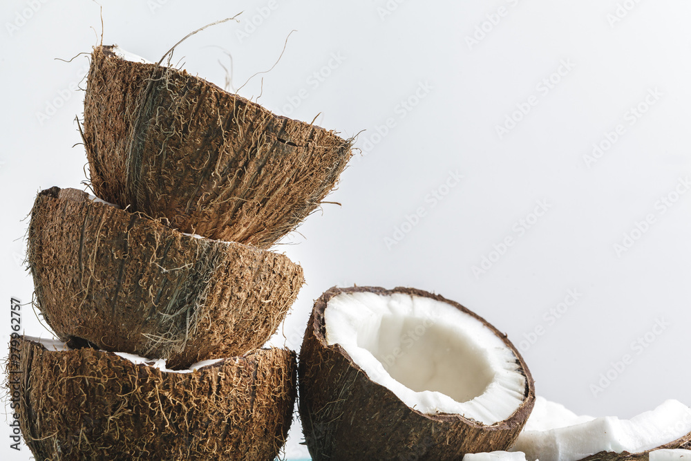 Ripe coconut pieces on white background, copy space Ripe coconut pieces on white background, copy space