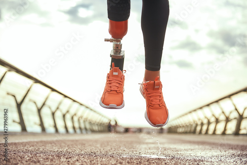 Konstfotografi Never give up Cropped photo of disabled woman with prosthetic leg in sportswear