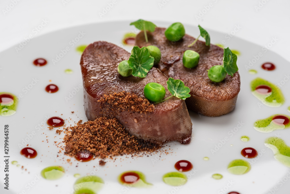 fried beef tongue with young peas, basil sauce and grated walnut