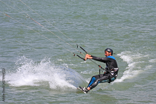 kitesurfer riding his board