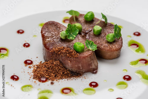 fried beef tongue with young peas  basil sauce and grated walnut