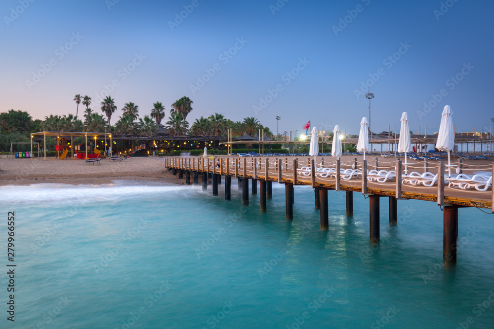 Obraz premium Beautiful scenery with wooden pier on Turkish Riviera at sunset, Side