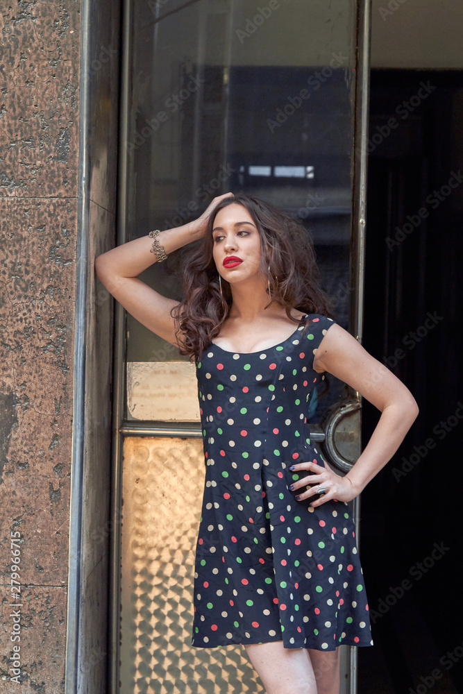 Fototapeta premium Young woman in dress posing in front of the camera.