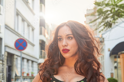 Elegant young woman posing on the street. Free Download Elegant young woman posing on the street. - GFXLoad