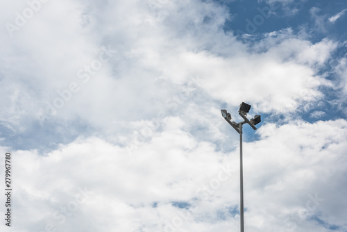 A white street lamp stands alone in the clear sky