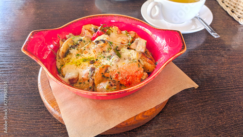 Baked chicken with vegetables and cheese in a pan. View from above.