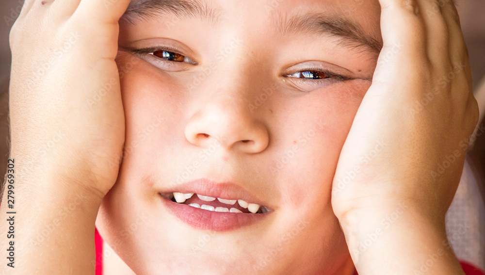 Close up portrait of a little boy with hands on your head Close up portrait of a little boy with hands on your head