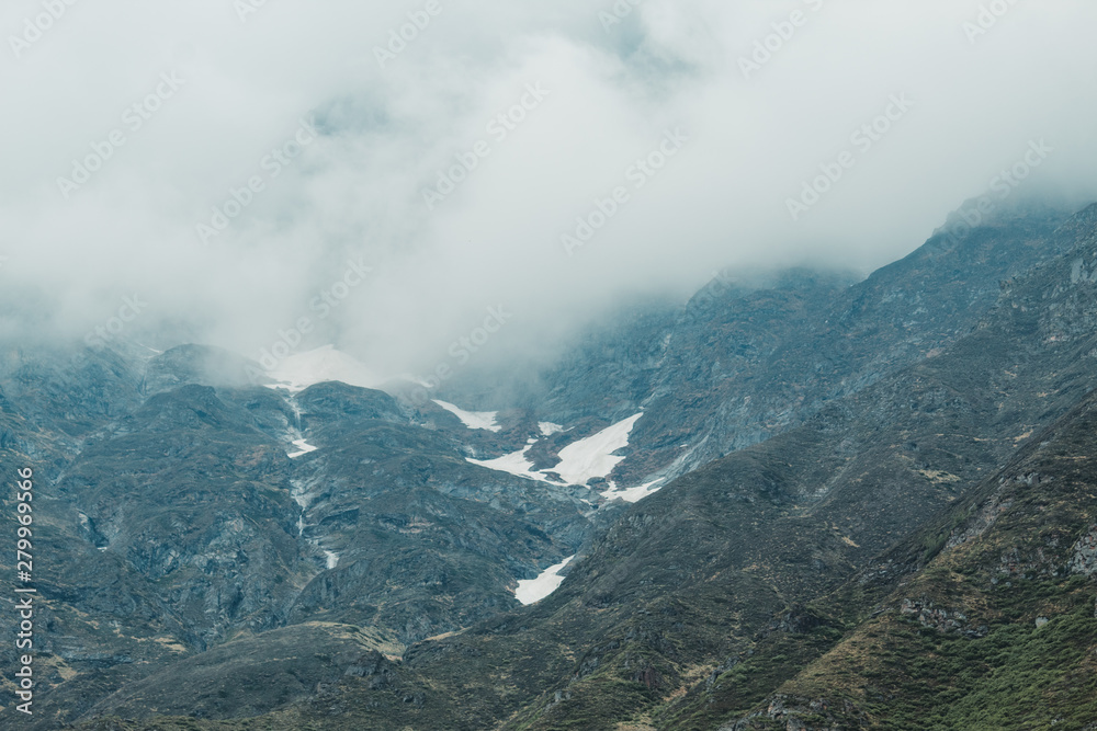 Snow covered mountains with clouds in Badrinath, Uttarakhand, India