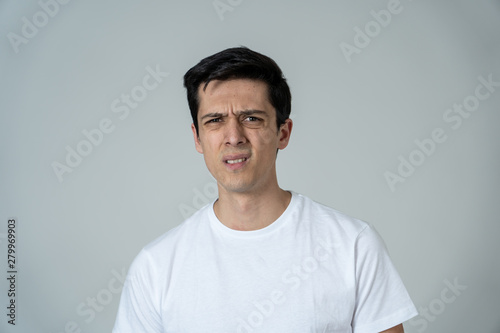 Portrait of a young man looking scared and shocked. Human expressions and emotions