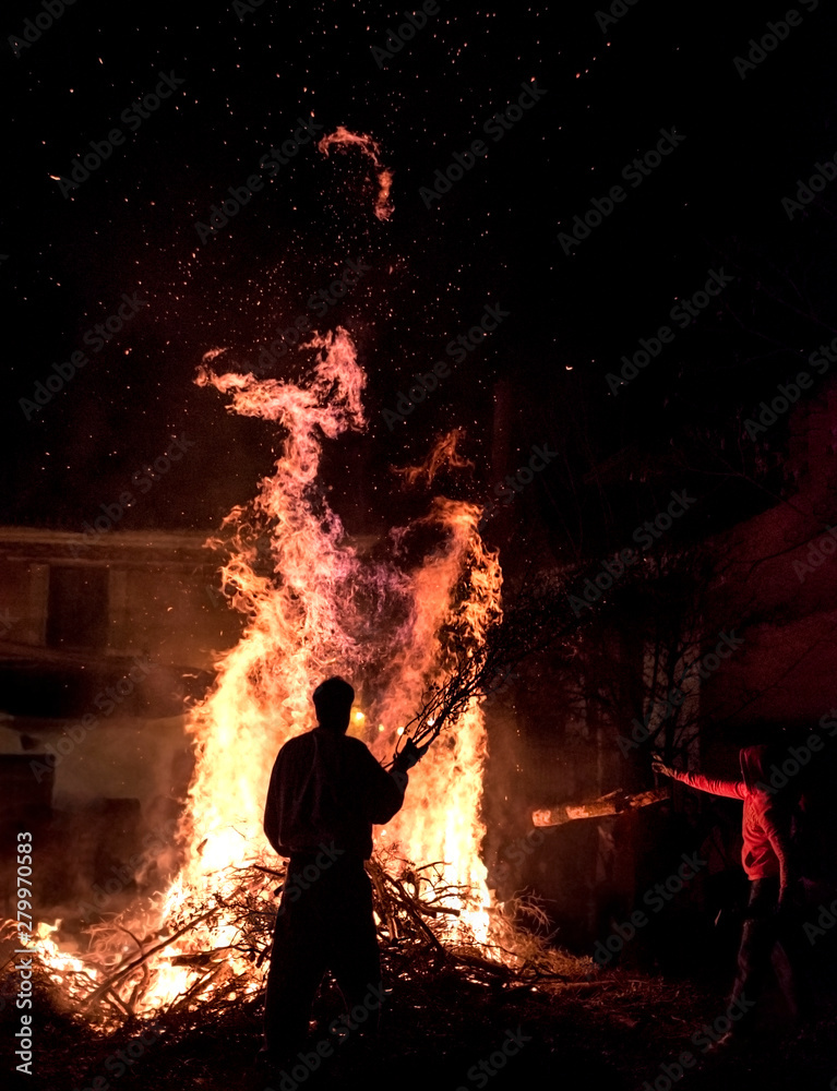 People celebrate St John's Eve around a bonfire in a greek village