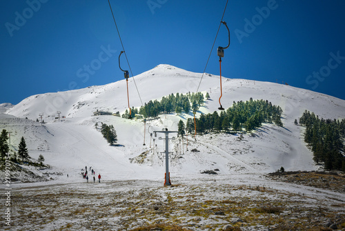 One of the peaks of Mount Helmos under a clear blue sky. Kalavryta town,  Peloponesse. Greece. photo