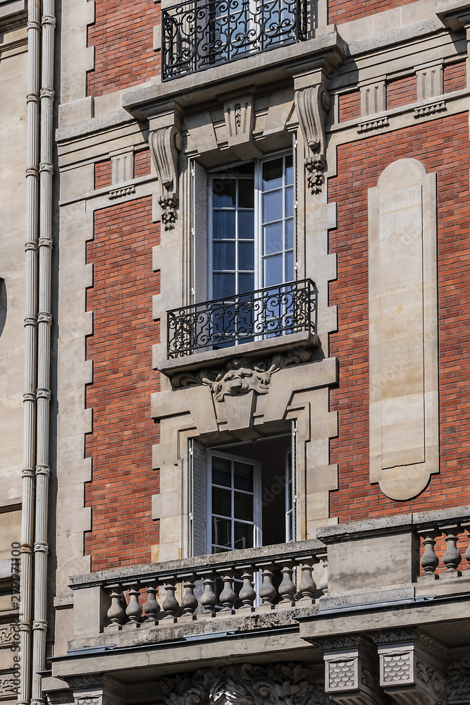 Naklejka premium Old French house with traditional balconies and windows. Paris, France.
