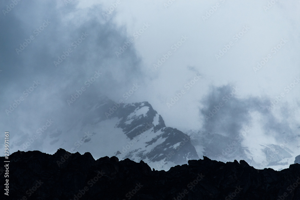 Clouds in front of snow covered mountains in Badrinath, Kedarnath, India