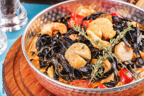  Mediterranean black pasta with shrimps, tomatoes, dumplings, rosemary and mushrooms