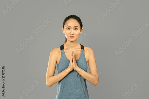 Asian woman practicing yoga...