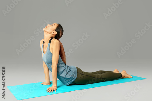 Asian woman practicing yoga...