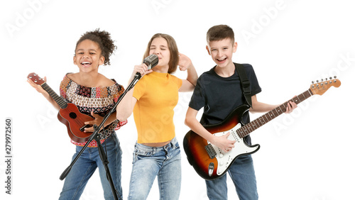 Fotografie Teenage musicians playing against white background
