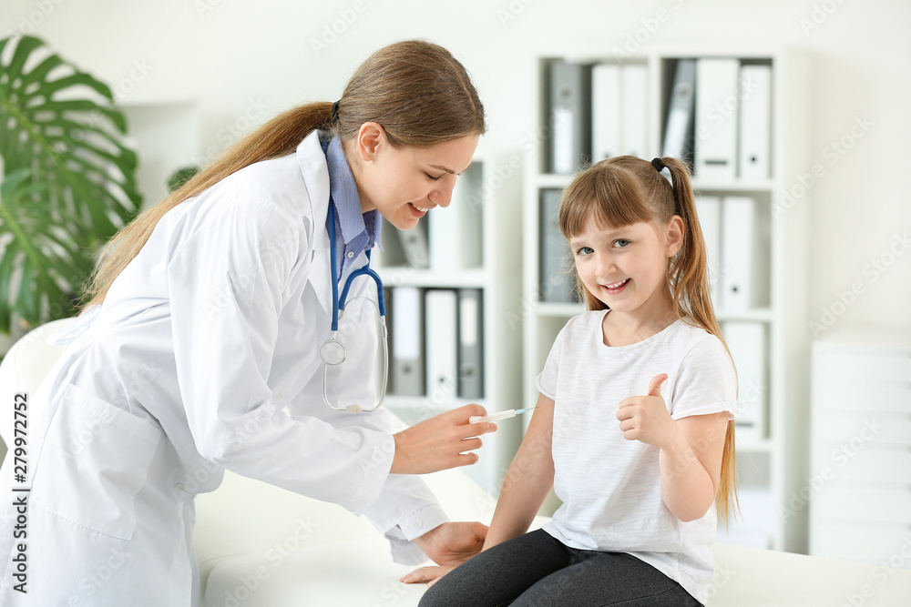 Doctor vaccinating little girl in clinic Doctor vaccinating little girl in clinic
