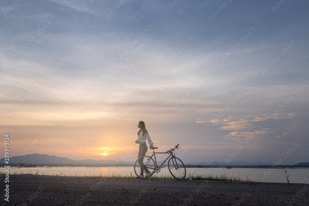 Fototapeta premium Cyclist on background of sunset, sport and travel concept
