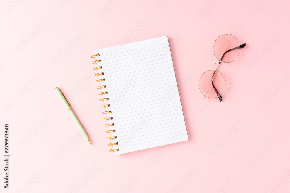 Fashion background with empty notebook and sunglasses Fashion background with empty notebook and sunglasses