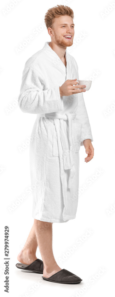 Handsome young man in bathrobe drinking coffee on white background Handsome young man in bathrobe drinking coffee on white background