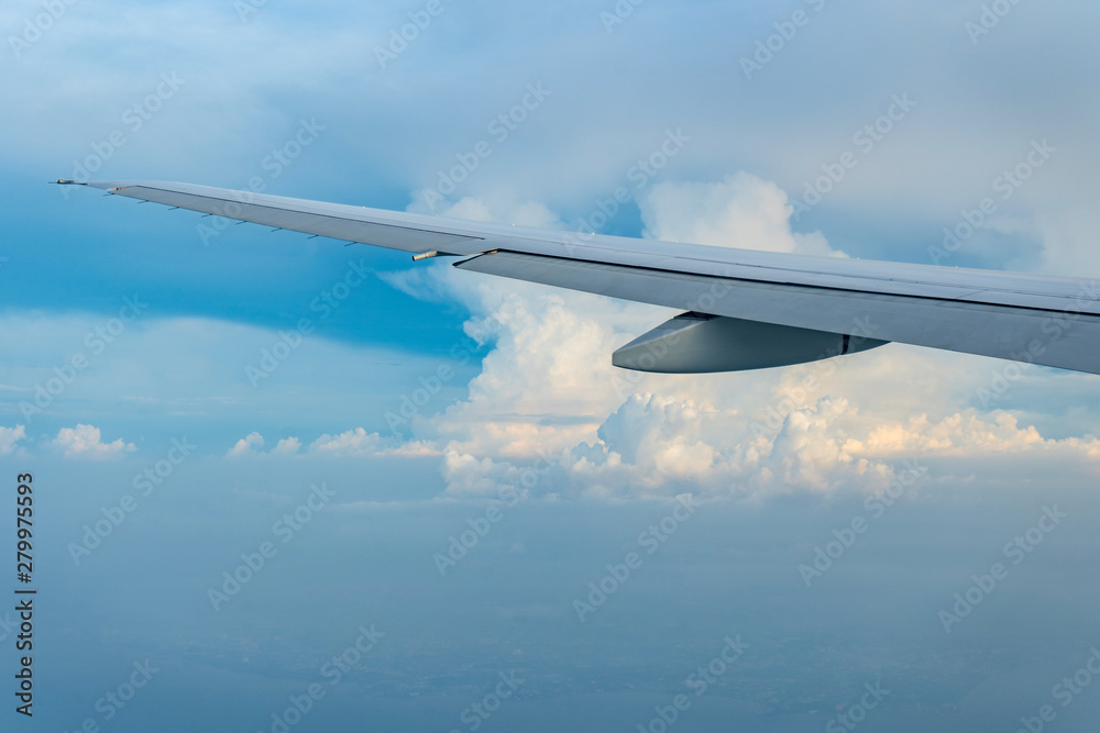 Flying and traveling, view from airplane window on the wing on sunset time Flying and traveling, view from airplane window on the wing on sunset time