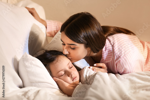 Woman putting her little da...