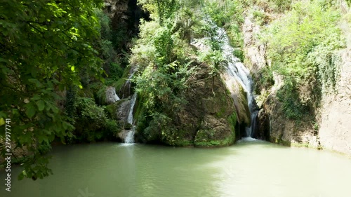 Zoom in drone shot of beautiful waterfall in the mountains. Aerial view