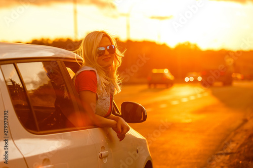 happy woman girl goes to summer travel trip in car. © Angelov