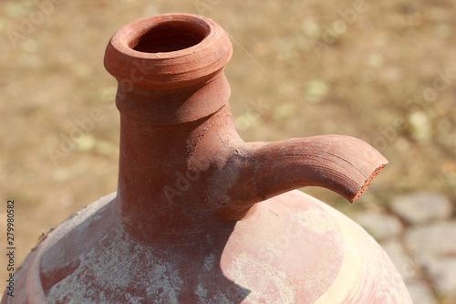 antique, earthen water pot, on color background