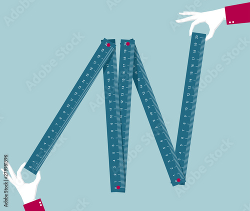 Take the folding ruler in your hand. Isolated on blue background.