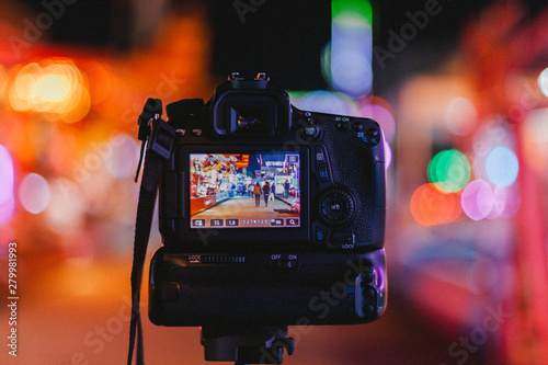 Photograph of a camera doing long exposure in a fun fair. France. photo