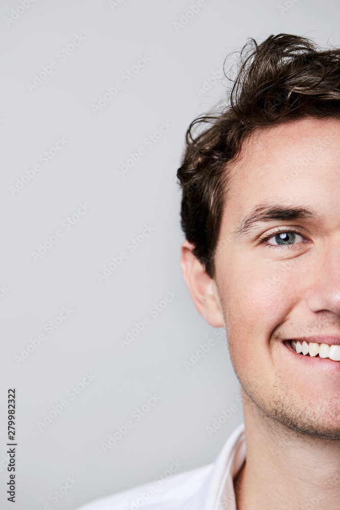Portrait of young man, smiling in close up Portrait of young man, smiling in close up